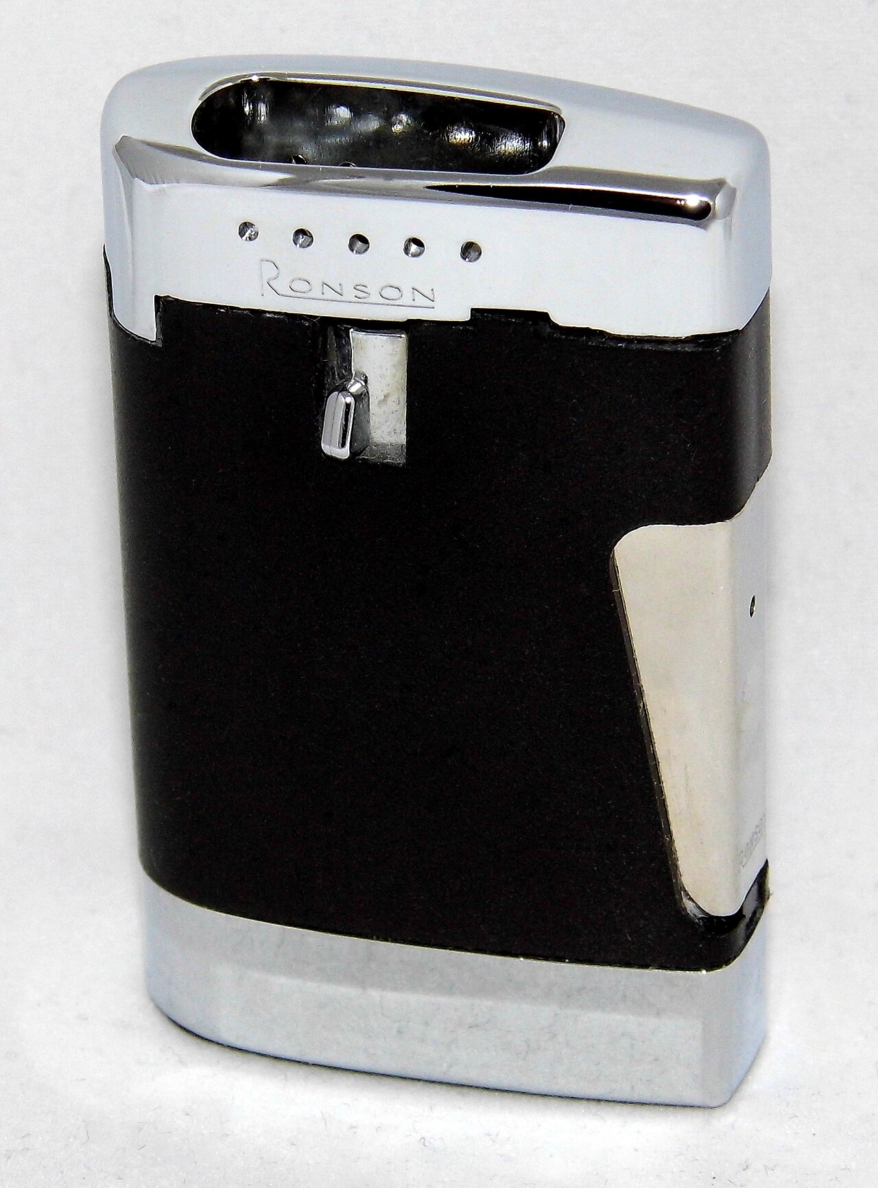 A vintage Ronson Varaflame Comet butane lighter, circa 1967, on a wood table