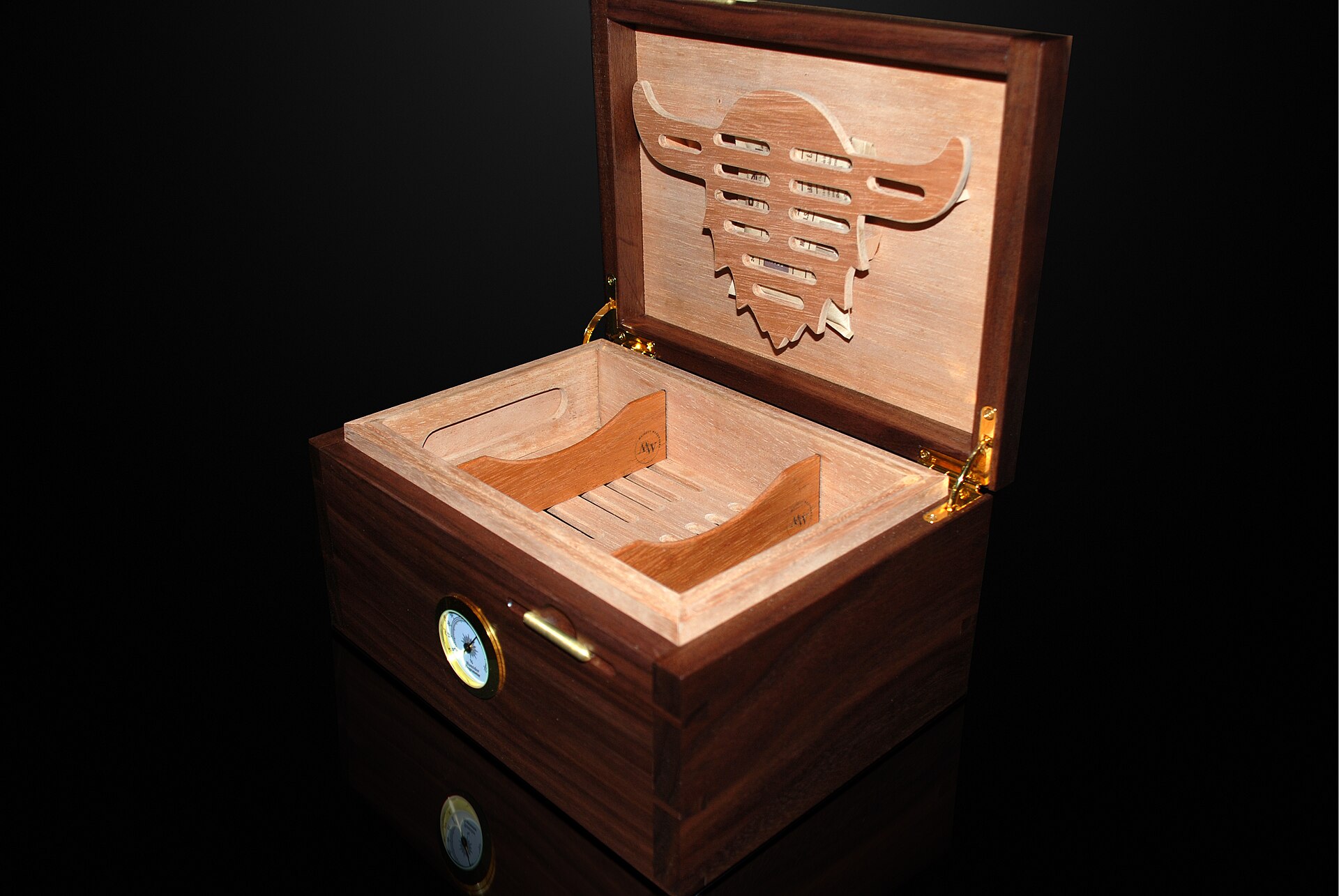 A walnut humidor with Spanish cedar interior and a Boveda humidity pack holder